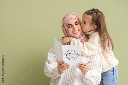 Young Muslim woman with gre...