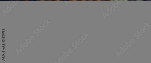 Colorful blue and white decorative eggs in woven baskets with straw on a wooden surface