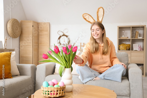 Young woman in bunny ears w...