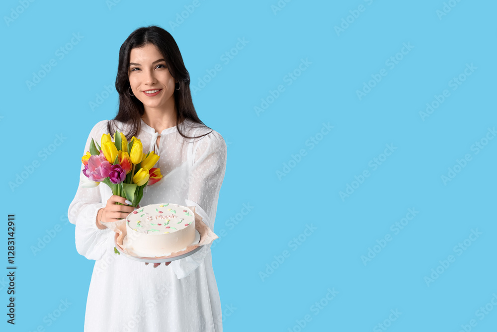 Beautiful young woman with sweet bento cake and bouquet of tulips on blue background. International Women's Day Beautiful young woman with sweet bento cake and bouquet of tulips on blue background. International Women's Day