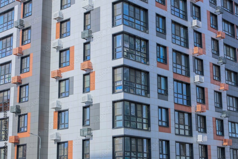 The concept of modern architecture, a residential complex, an apartment building for living. Close-up of the corner of the house in the camera multi-storey, apartment building in gray and white tones The concept of modern architecture, a residential complex, an apartment building for living. Close-up of the corner of the house in the camera multi-storey, apartment building in gray and white tones