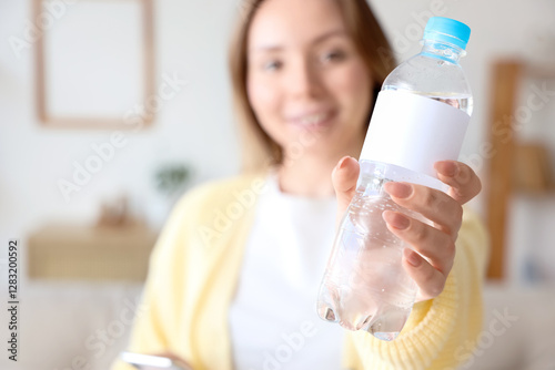 Young woman with bottle of ...