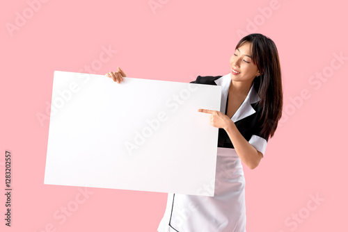 Young Asian chambermaid wit...