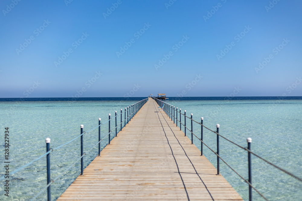 Long wooden pier stretching into the crystal clear sea of marsa alam, egypt Long wooden pier stretching into the crystal clear sea of marsa alam, egypt
