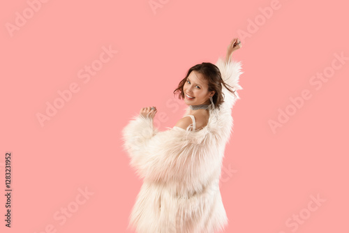 Young woman in fur coat dan...