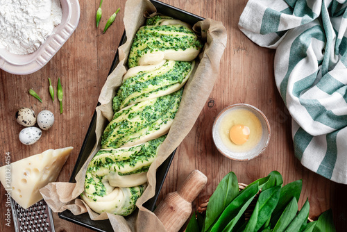 Homemade bread with wild garlic pesto on a wooden background.