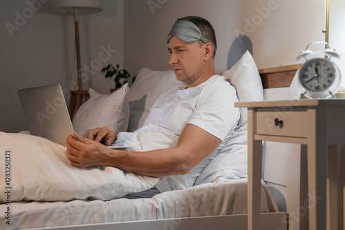 Mature man using laptop in ...
