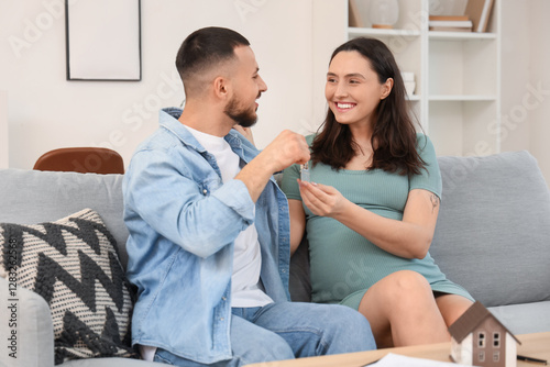 Young pregnant couple with ...