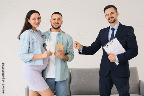 Male realtor giving key fro...