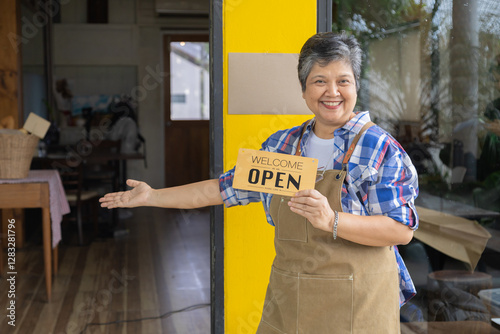 Asian elderly, senior, pensioner, female open cafe restaurant small business at home town after retirement, healthy strong 60s woman happy lifestyle wearing apron working as barista waitress worker photo