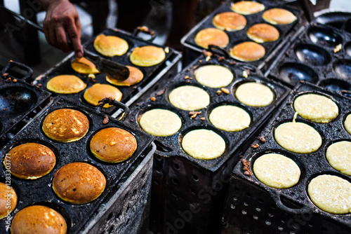 The process making Apem Cake or Kue Apem at Ngasem market (traditional market) in Yogyakarta, Indonesia. Kue Apem is traditional Javanese snacks made from rice flour. photo
