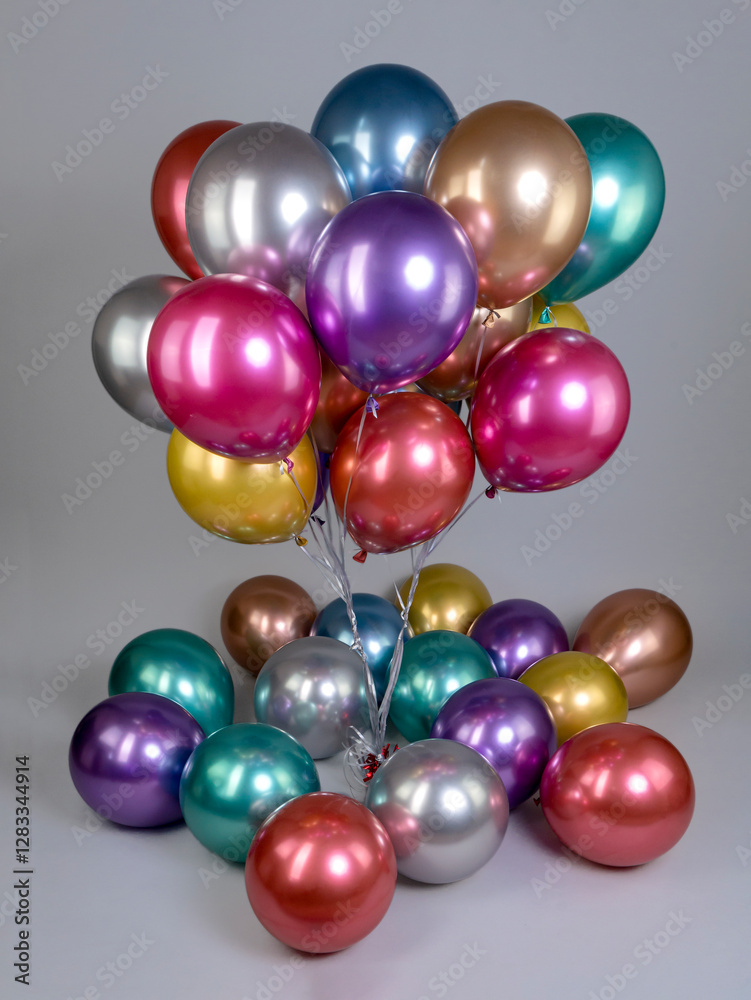 Fountain of multicolored metallic flowers balloons on gray background Fountain of multicolored metallic flowers balloons on gray background