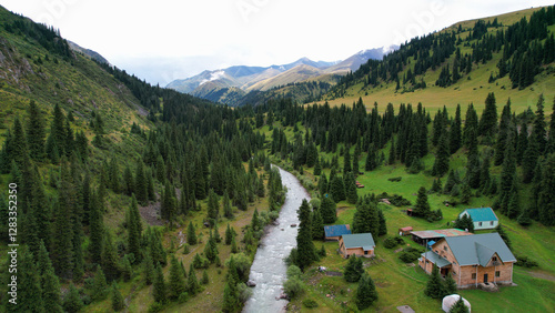 Obraz na płótnie Breathtaking aerial view capturing a river meandering through a lush green valley surrounded by the majestic tian shan mountains and dotted with cozy houses w salonie