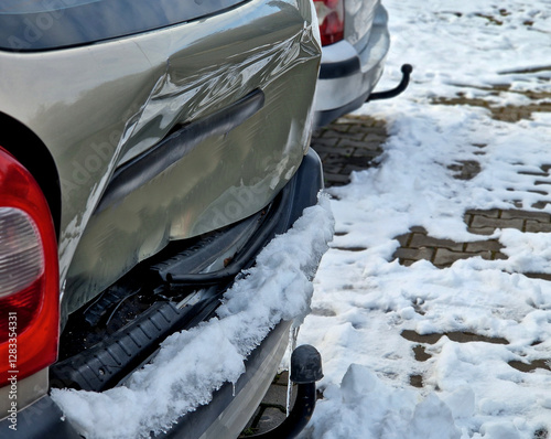 dented car trunk lid. at once when backing up or not braking when the distance is wrong. emergency braking. a plumber will fix your car cheaply photo