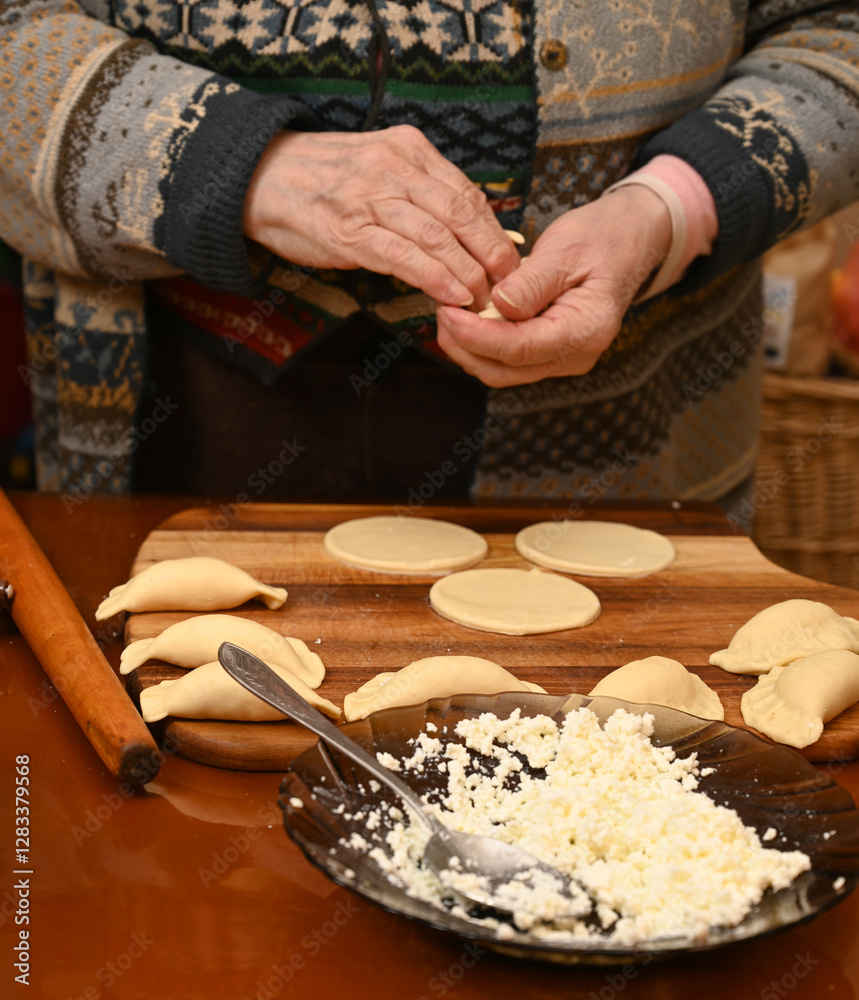 Woman skillfully fills dough circles with cheese in a warm kitchen