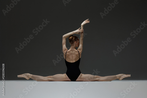 Young beautiful ballerina is posing in studio