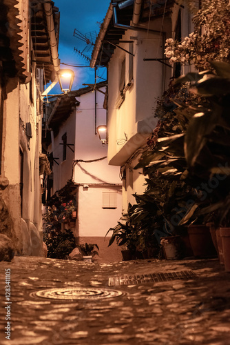 Beautiful nightfall view of a typical and narrow street in the Jewish Quarter of Hervás at night,  one of the best preserved in Spain, an Ambroz Valley village at Caceres, Extremadura, Spain. 