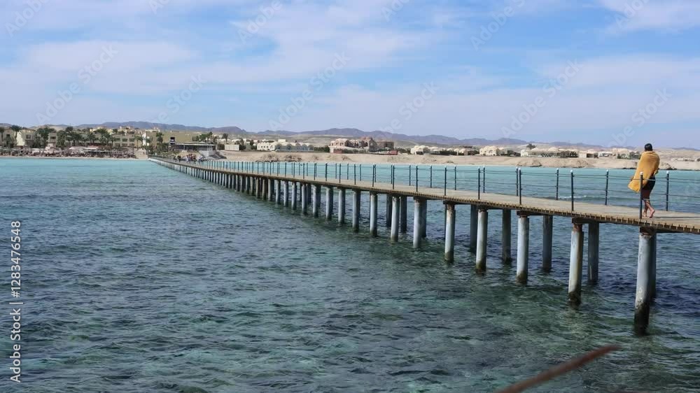Tourist walking on a pier in marsa alam, egypt Tourist walking on a pier in marsa alam, egypt