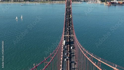 The 25 April bridge (Ponte 25 de Abril) located in Lisbon, Portugal, crossing the Targus river. Drone. 4k