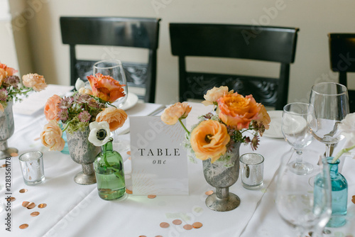 Slika na platnu Elegant table setting with floral arrangements and charming decor for a special