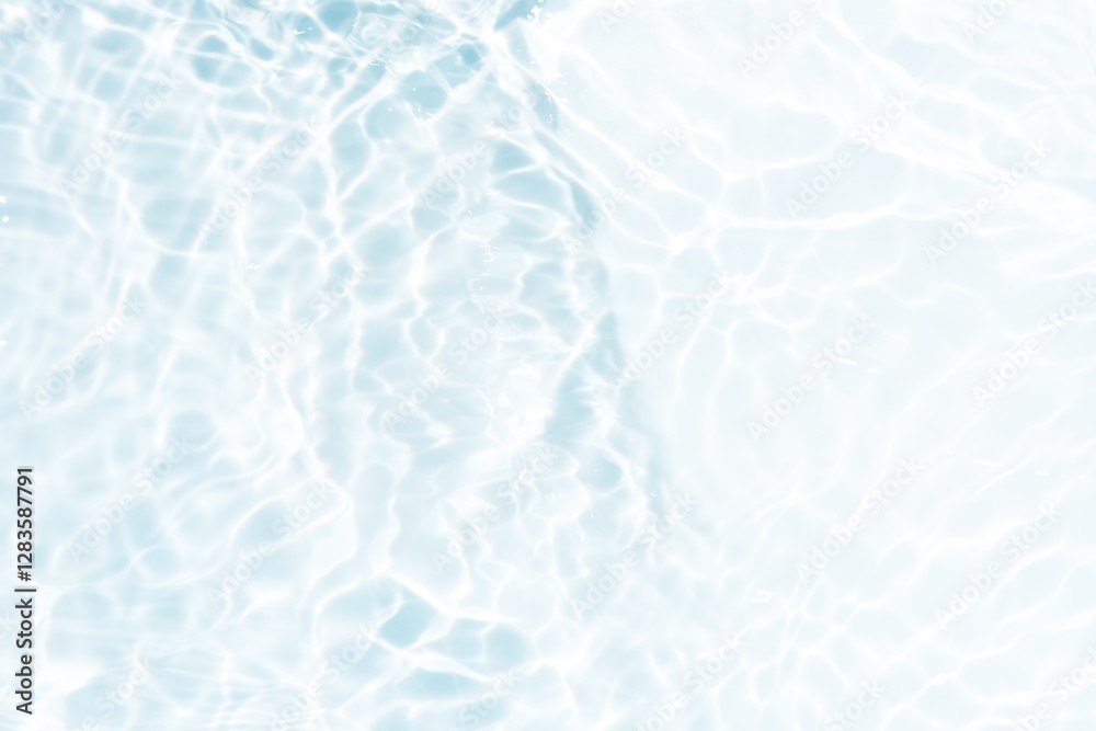 Blue water with ripples on the surface. Defocus blurred transparent blue colored clear calm water surface texture with splashes and bubbles. Water waves with shining pattern texture background.