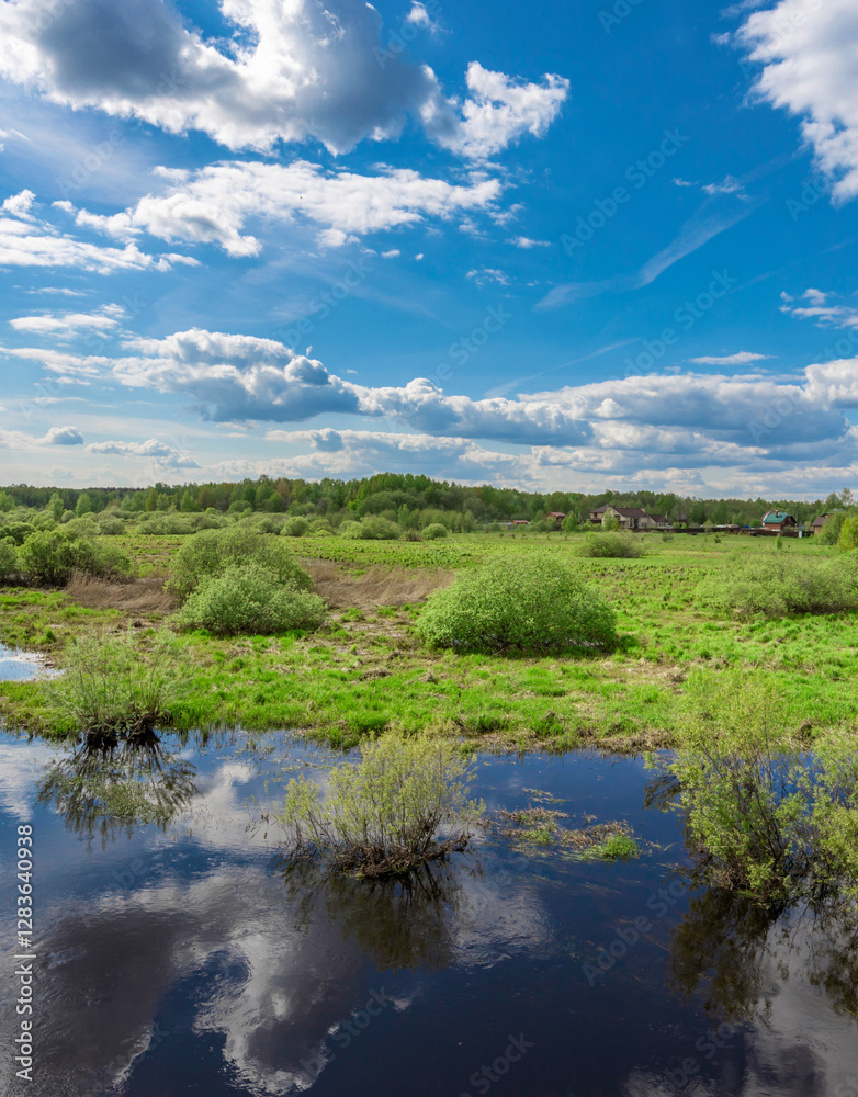 Field with a body of water in the foreground Field with a body of water in the foreground