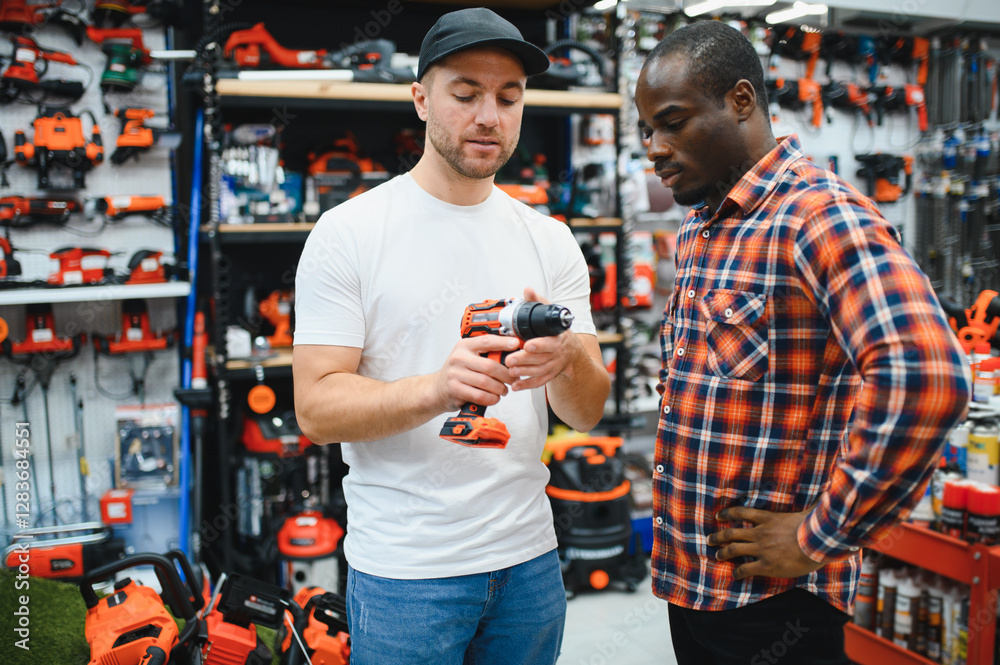 The seller helps the buyer choose a screwdriver in a hardware store. The seller helps the buyer choose a screwdriver in a hardware store.