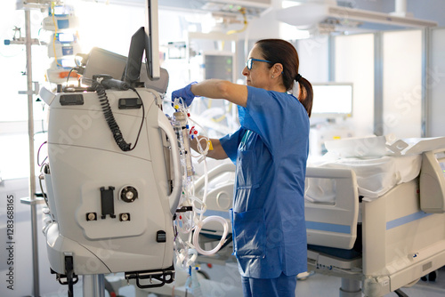 Konstfotografi nurse setting up hemofiltration machine in the icu