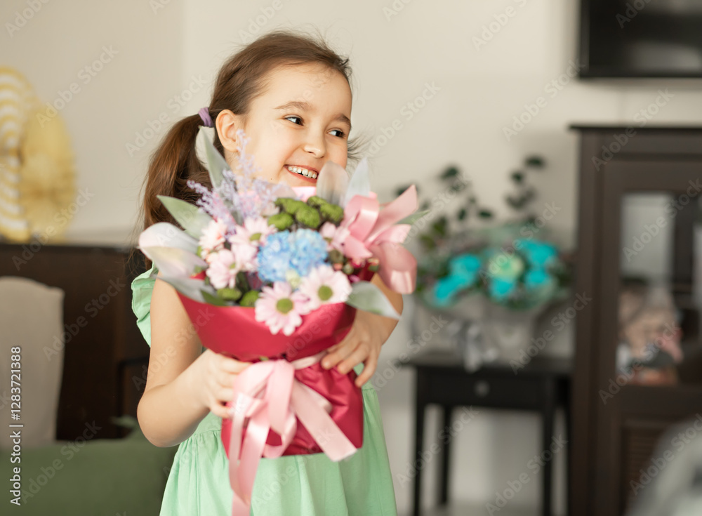 Cute little girl child holding bouquet with flowers indoor at home Cute little girl child holding bouquet with flowers indoor at home