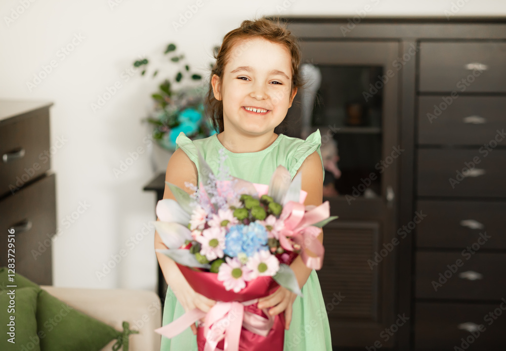 Cute little girl child holding bouquet with flowers indoor at home Cute little girl child holding bouquet with flowers indoor at home