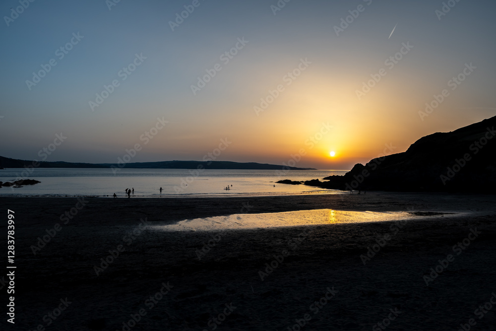 Fototapeta premium Sunset On On Pwllgwaelod Beach And Dinas Head At The Wild Atlantic Coast Of Pembrokeshire In Wales, United Kingdom