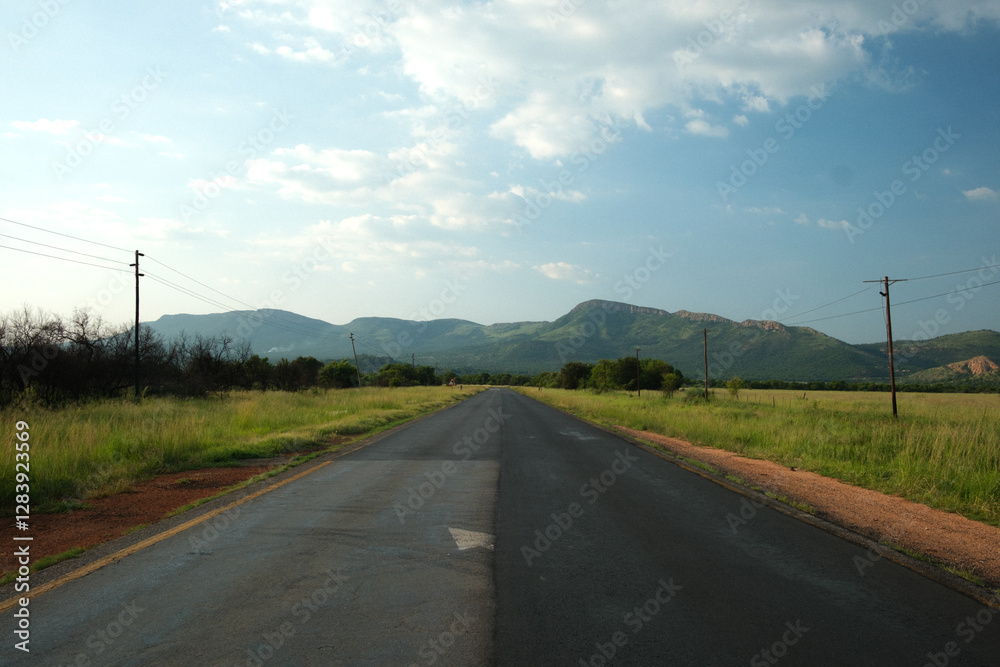 straight road heading towards mountains straight road heading towards mountains