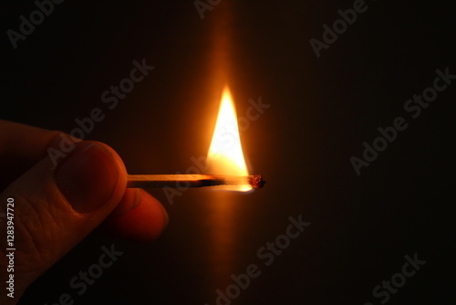 burning match on a black background