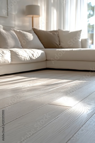A softly lit modern living room featuring a plush sectional couch and light-colored wooden flooring, creating a warm and inviting atmosphere.