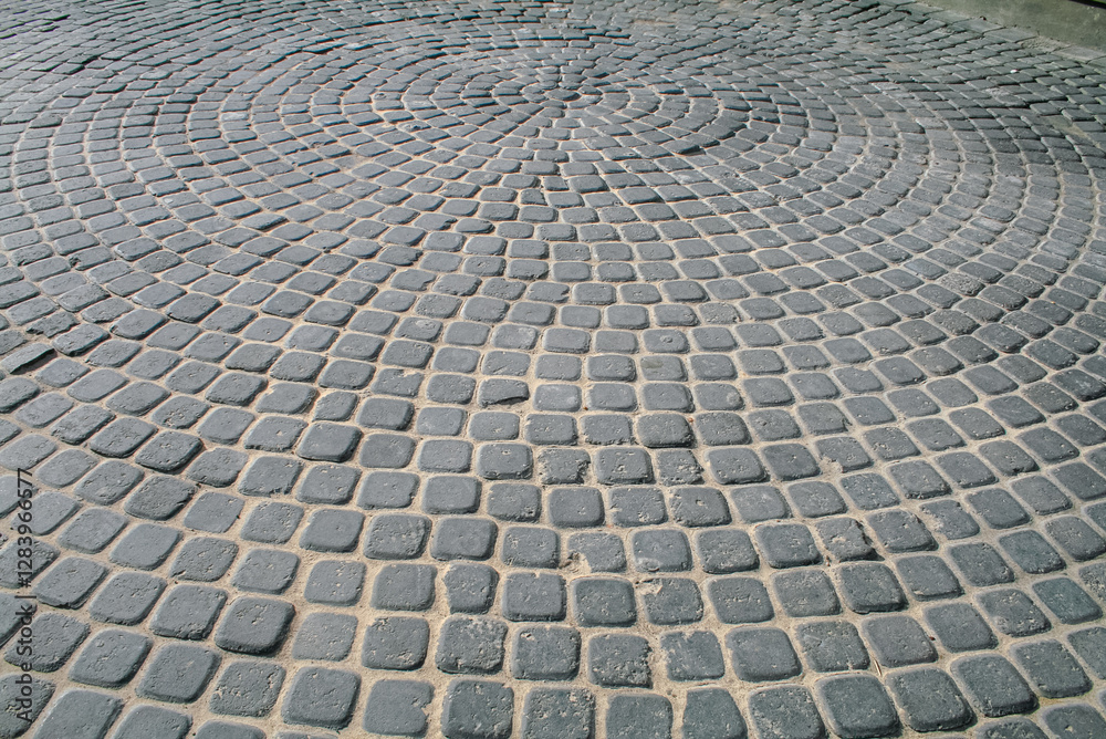 Patterned Cobblestone Pavement with Spiral Design in Urban Setting Patterned Cobblestone Pavement with Spiral Design in Urban Setting