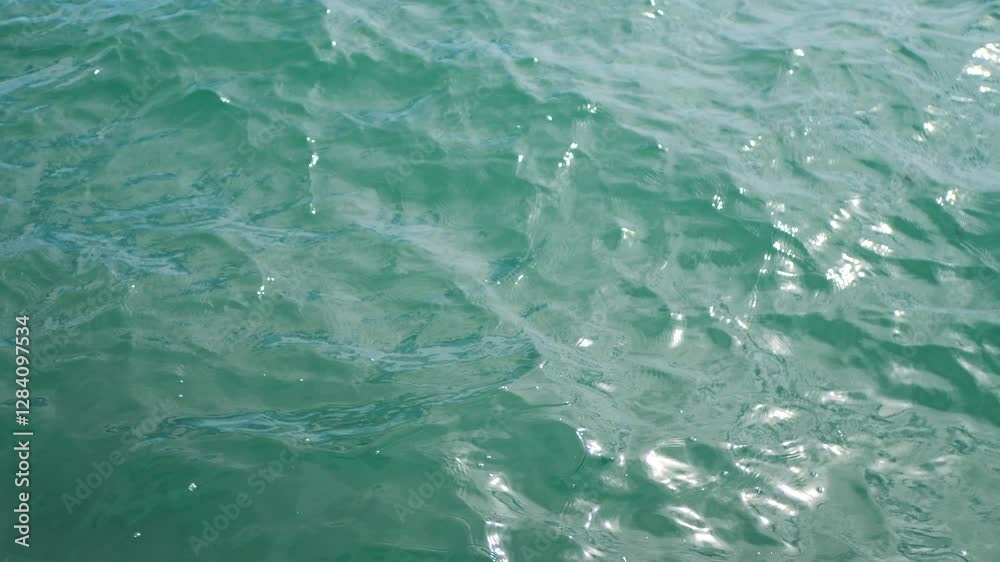 top view light turquoise water surface waving with light ripples top view light turquoise water surface waving with light ripples
