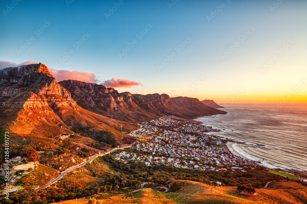 Fototapeta premium Cape Town Sunset over Camps Bay Beach with Table Mountain and Twelve Apostles in the Background