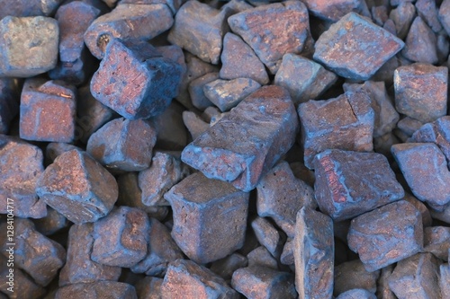 Natural blue nila pure indigo dye stones close up at traditional oriental street souk as background.