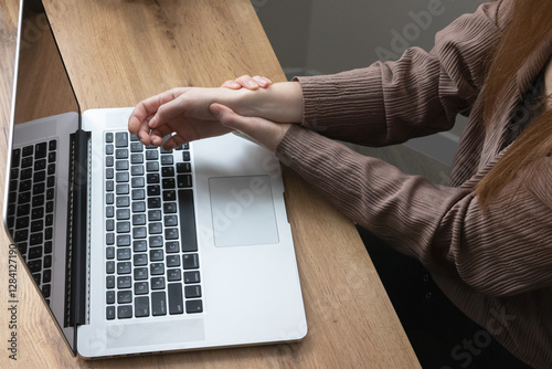 Сlose up of  woman’s hands suffering from carpal tunnel syndrome. Symptoms of office syndrome.
