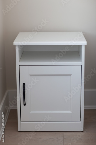 Wallpaper Mural white bedside table with black fittings in the bedroom, close-up Torontodigital.ca