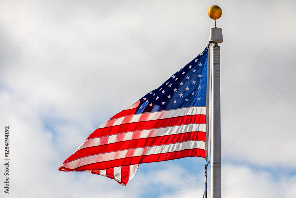 Obraz premium American flag waving with clouds in the background