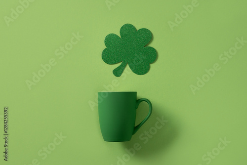 Obraz na płótnie Patrick's Day celebration concept. Green cup for coffee and shamrock on green background. Copy space. Close up. w salonie
