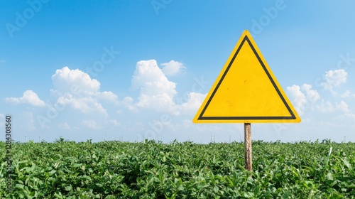 Empty Warning Sign in a Field Under a Clear Sky. Possible Use Stock Photo