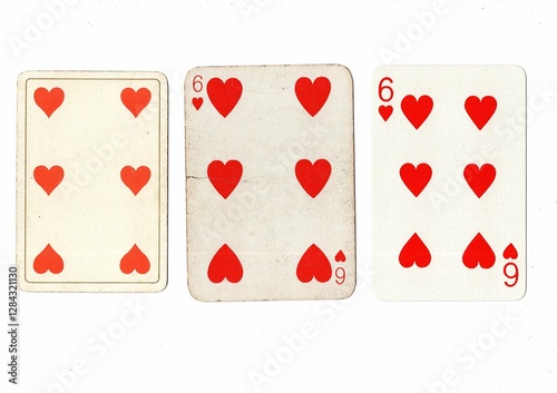 Vintage playing cards in three different designs showing the same value. photo