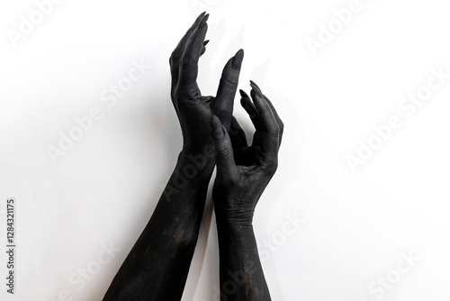 The woman hands with long nails painted in black color.
