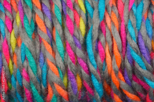 A close-up shot of a skein of multicolored yarn, showcasing its texture and vibrant color combinations