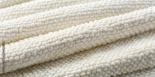A close-up view of soft, textured fabric featuring a neutral tone. The fabric showcases a plush surface, making it ideal for upholstery and clothing. The intricate patterns add depth and warmth
