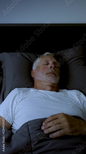 Wallpaper Mural Mature adult sleeping at night. Vertical Video. Torontodigital.ca