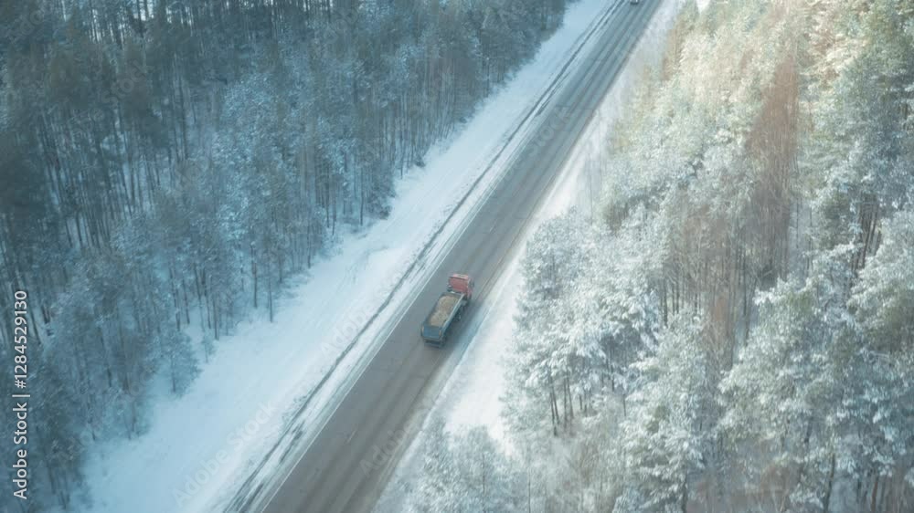 Truck driving in winter snow and ice covered road, dangerous conditions, lorry heavy transport, cargo shipping, forest road Truck driving in winter snow and ice covered road, dangerous conditions, lorry heavy transport, cargo shipping, forest road