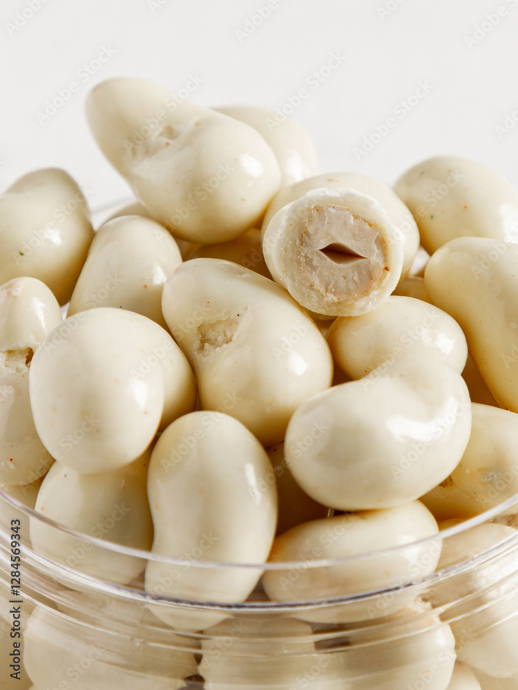 Cashew nuts in milk chocolate close-up.